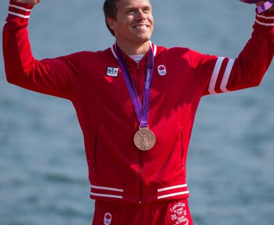 Canada's Mark de Jonge celebrates during the victory ceremony after winning a bronze medal in the K-1 200m at the 2012 London Olympic Games, August 11, 2012. The podium victory brought Canada even with its medal tally at the 2008 Beijing Games at 18. (COC Photo: Jason Ransom) Canada's Mark de Jonge celebrates during the victory ceremony after winning a bronze medal in the K-1 200m at the 2012 London Olympic Games, August 11, 2012. The podium victory brought Canada even with its medal tally at the 2008 Beijing Games at 18. (COC Photo: Jason Ransom)